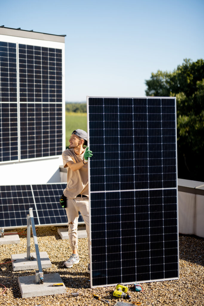 Portrait of a man standing with solar panel